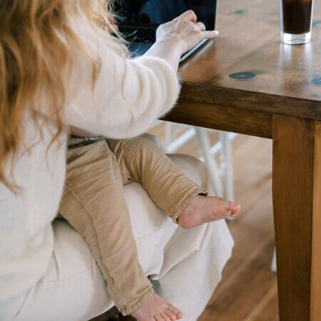 mom logging onto computer for sleep coaching